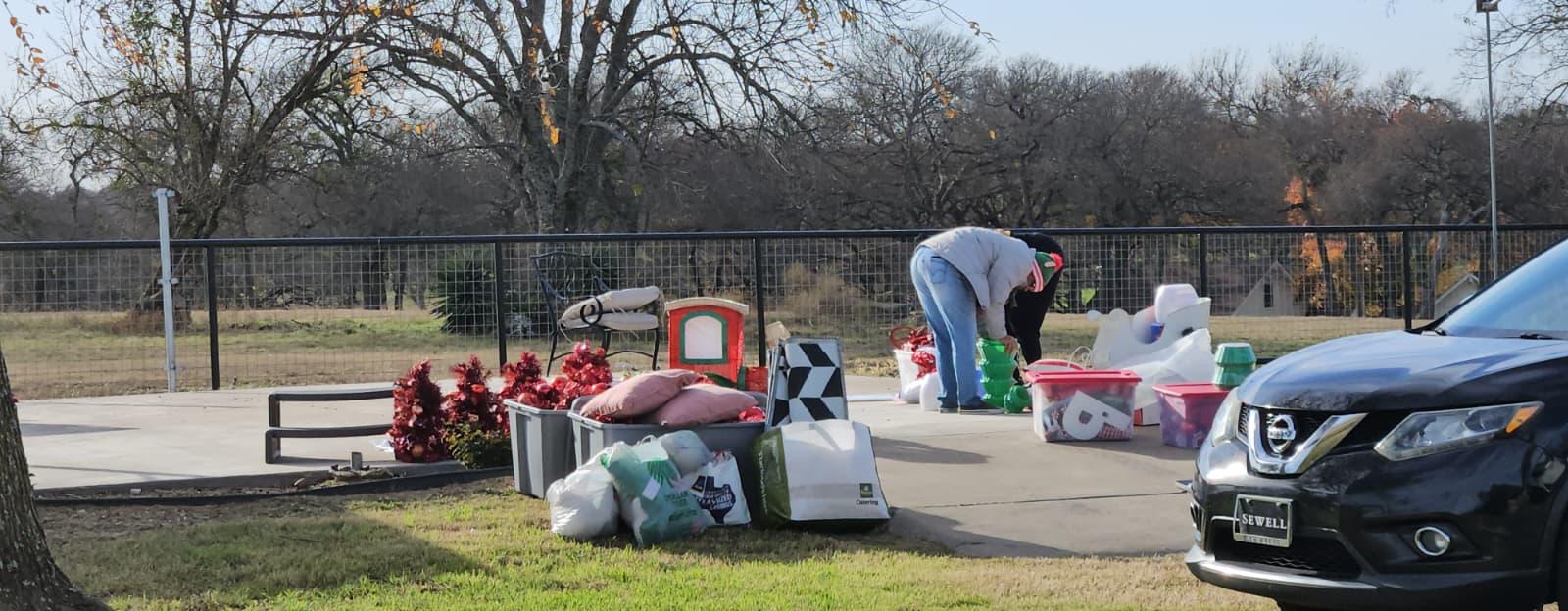 Volunteers unpacking holiday decor