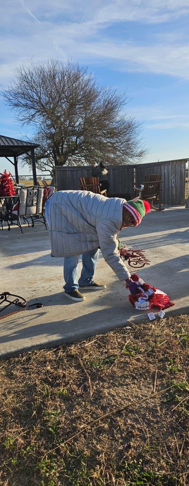 A volunteer setting up holiday decorations