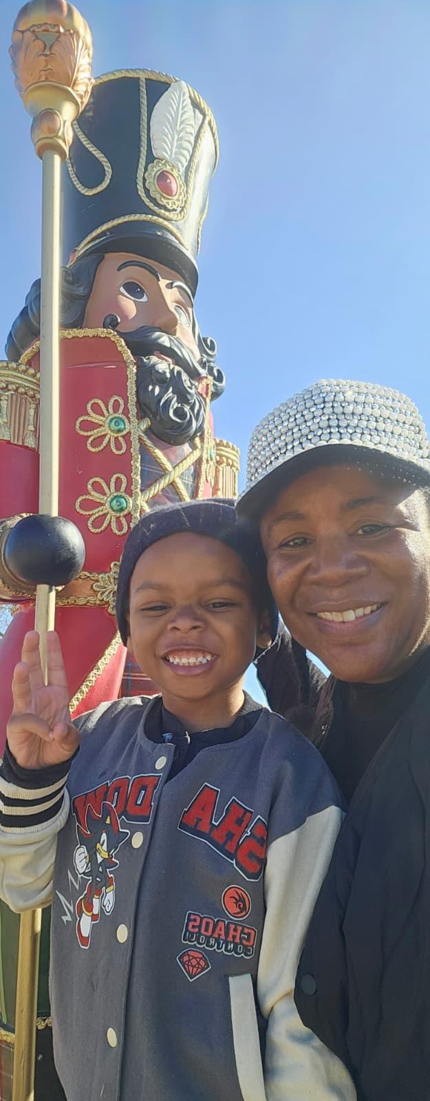 Tara and a young guest smiling beside the nutcracker